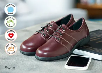 A pair of burgundy shoes on a table