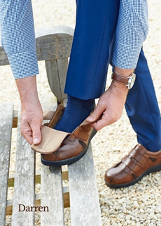 Man kneeling down adjusting shoe strap