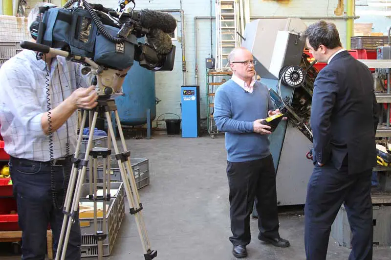 TV presenter interviewing a man