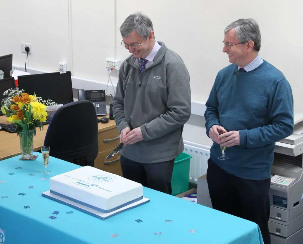Men cutting a cake