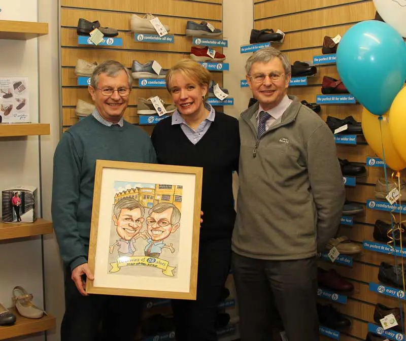 2 men and a woman holding a picture