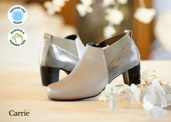 A pair of beige heeled boots on a table