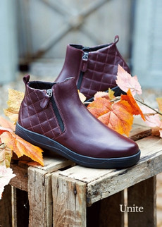 Pair of burgundy boots on a box