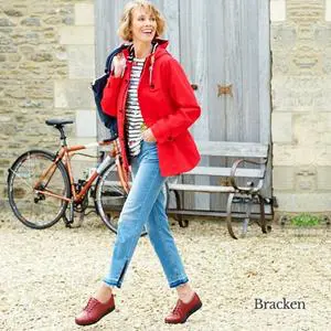Woman in red coat wearing brown shoes