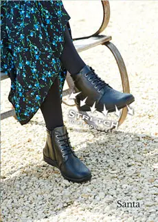 WOman wearing black boots with a dress