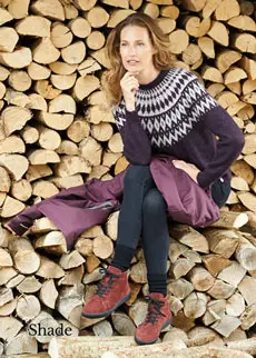Woman wearing shoes sitting on a log pile