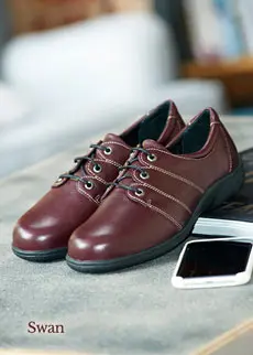 Pair of burgundy shoes on a table