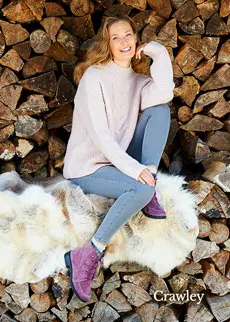 WOman sat on logs with purple boots