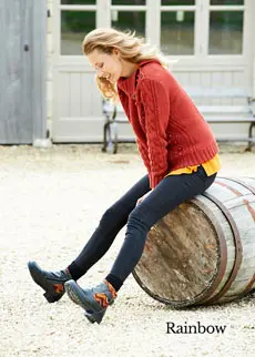 Woman sat on a barrel wearing boots