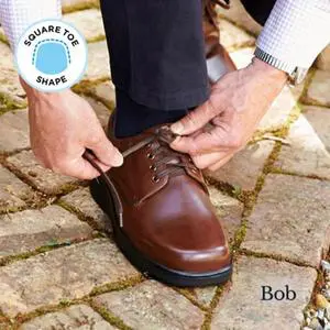 A man lacing up a brown shoe