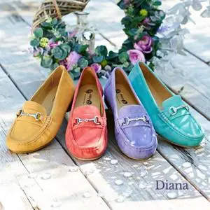 4 different colours loafers in the same style by some flowers
