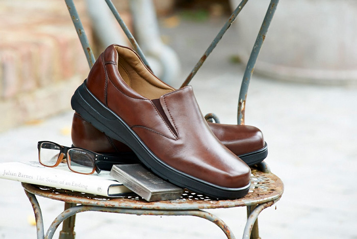 A pair of brown shoes on a chair