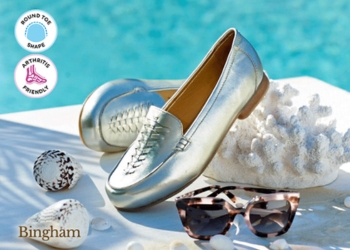 A pair of silver flat shoes next to a pool