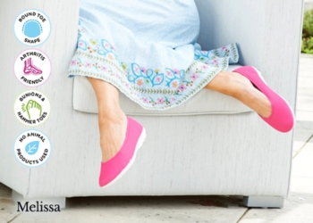A woman wearing a pair of pink canvas and blue dress
