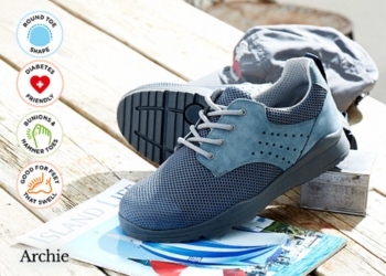 A pair of two tone blue trainers on a table