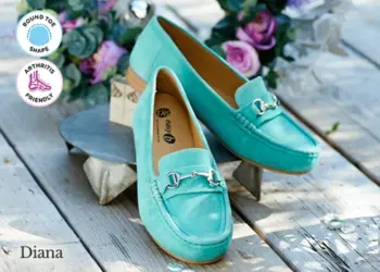 A pair of blue slip on shoes on a table