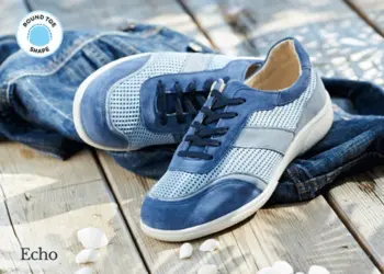 A pair of blue lace up trainers on decking