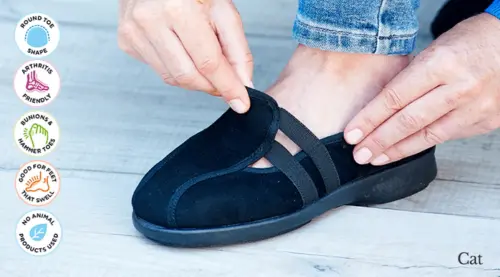 A woman adjusting a black slipper