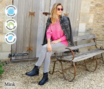 A woman sat on a bench wearing black boots