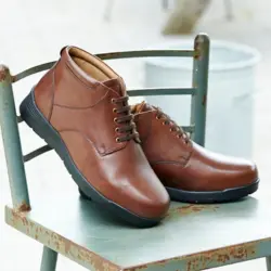 A par of mens brown boots on a chair