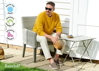 A man sat at a table in a garden