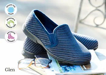 A pair of mens blue slippers on a chair