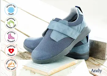 A pair of mens blue strap trainers on decking
