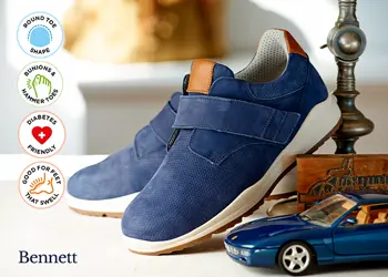 A pair of blue strap trainers on a table