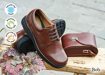 A pair of mens brown lace up shoes on a bench