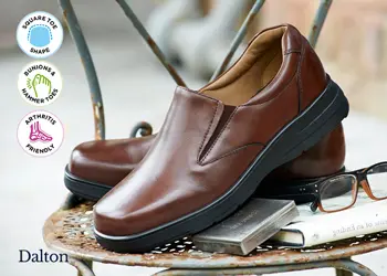A pair of men's slip on shoes on a chair