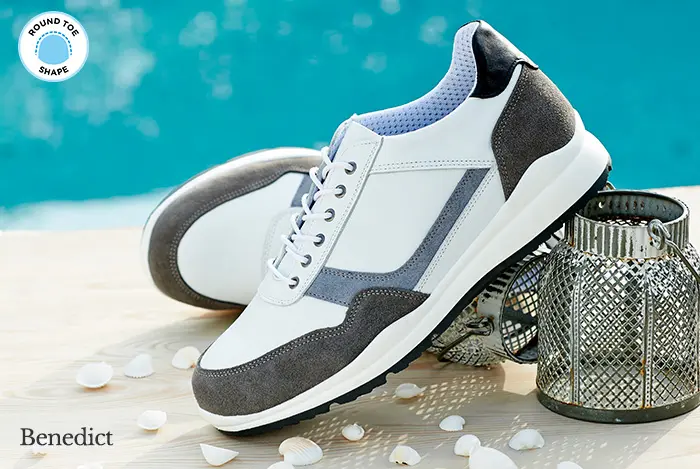 A pair of white trainers by the pool