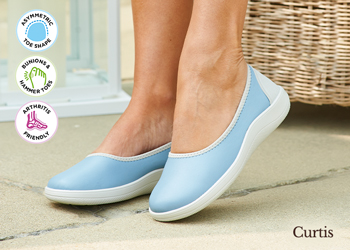 A woman wearing a pair of blue canvas shoes