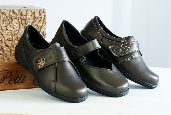 A trio of different flat leather shoes with straps