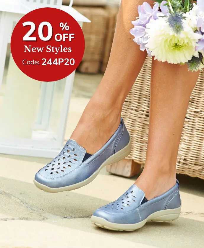 A woman sat wearing blue slip on shoes