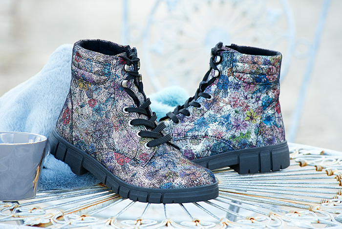 A pair of floral lace up boots