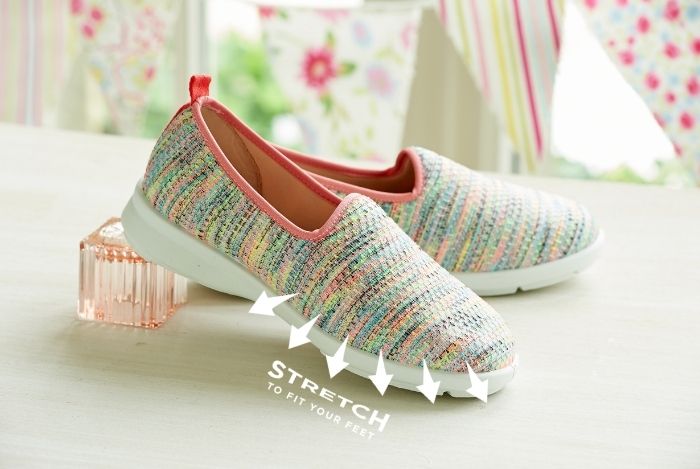 A pair of canvas shoes on a table with stretch marking over them