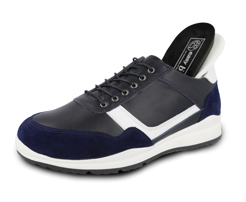 A black and white lace trainer with an insole sticking out