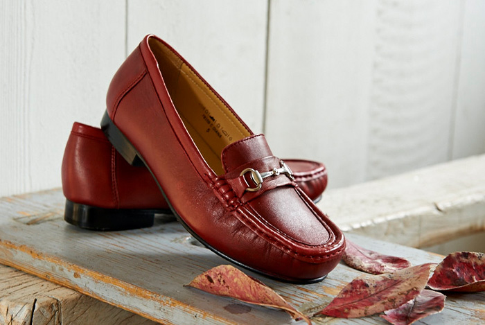 A pair of brown womens loafers on a table