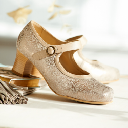 A pair of gold heeled shoes on a table