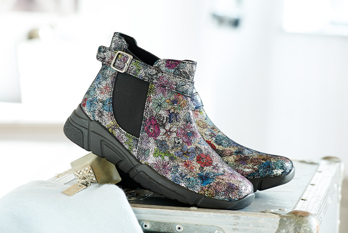 A pair of floral buckle up chelsea style boots