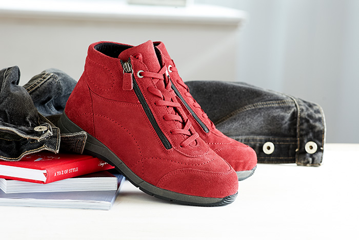 A pair of red lace and zip up boots on a table