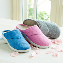 3 mule slippers on a table in different colours