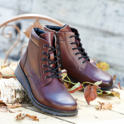 A pair of brown lace up ankle boots on a table