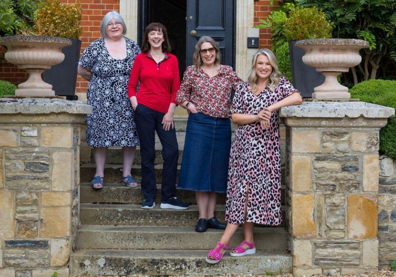 4 women including Sara Davies MBE standing on the steps of a house entrance