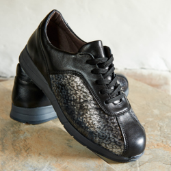 A pair of black and shiny floral trainers